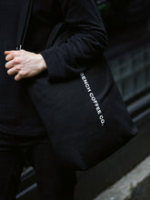 Load image into Gallery viewer, BENCH COFFEE CO. BAGGU tote bag in use
