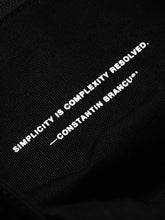 Load image into Gallery viewer, Quote on the inside pocket of BENCH COFFEE CO. BAGGU tote bag, &quot;Simplicity is complexity resolved. —Constaintin Bracusi&quot;
