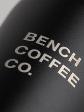 Load image into Gallery viewer, Detail shot of Made by Fressko reusable cup, with BENCH COFFEE CO. logo, in black
