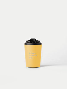 Made by Fressko reusable cup, with BENCH COFFEE CO. logo, in yellow